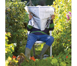 Man Reading Newspaper In Garden