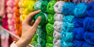 Close,Up,Of,Yarn,Balls.,Girl,Hand,Choosing,Yarn,In