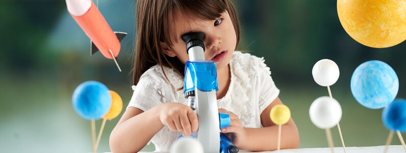 Curious,Little,Girl,Looking,Through,Microscope,While,Having,Fun,In
