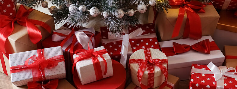 Pile,Of,Gift,Boxes,Near,Beautiful,Christmas,Tree,Indoors
