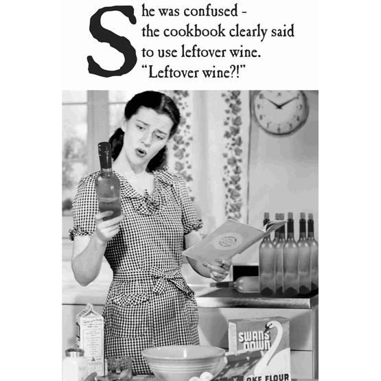 Woman Cooking And Looking At A Bottle Of Wine